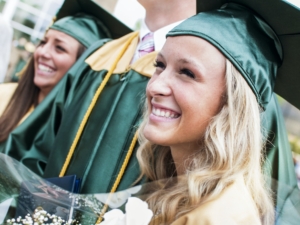Close-up Of Happy Young Woman With Friends At Graduation Ceremony